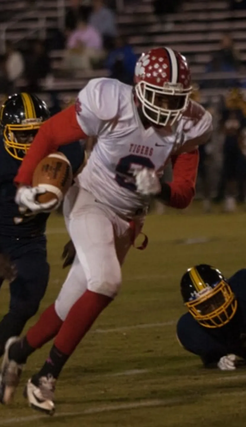 Sussex Central running back breaking through defenders