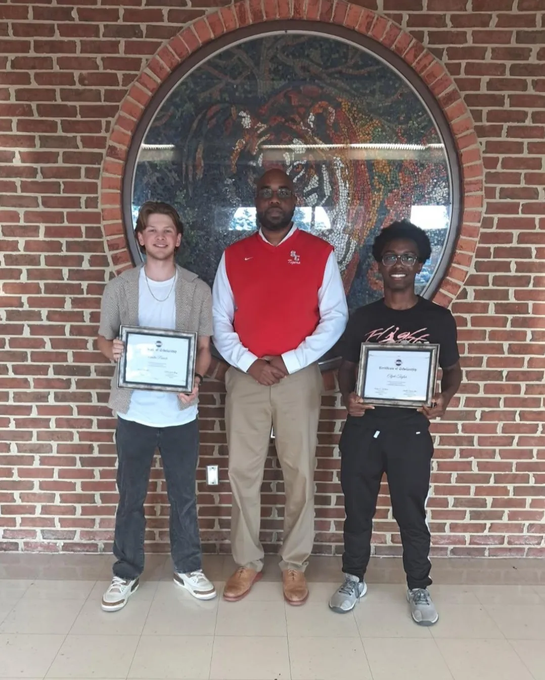 Sussex Central students proudly holding scholarship award certificates